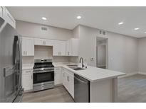 Well-lit kitchen with stainless steel appliances, a breakfast bar and white cabinetry at 5751 E Hacienda Ave # 159, Las Vegas, NV 89122
