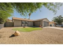 Charming single-story home with gravel landscaping, healthy trees, and an attached two-car garage at 6330 Spring Meadow Dr, Las Vegas, NV 89103