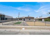Charming single-story home featuring a fenced front yard and neutral gray paint at 636 Burton St, Henderson, NV 89015