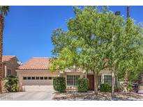 Charming single-story home featuring a well-manicured front yard and a two-car garage at 8800 Crescent Ridge Ln, Las Vegas, NV 89134