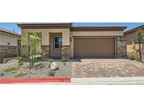 Charming single-story home featuring a brick driveway, desert landscaping, and a two-car garage at 107 Barkset Way, Henderson, NV 89011