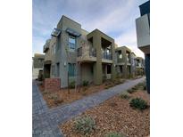 Modern two-story townhome featuring private balconies and contemporary architectural details at 11289 Vision Peak Ave # 103, Las Vegas, NV 89135
