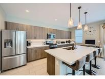 Modern kitchen featuring a large island, stainless steel appliances, and stylish pendant lighting at 11289 Vision Peak Ave # 103, Las Vegas, NV 89135