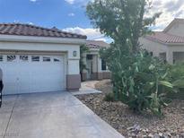 Charming single story home with desert landscaping and attached garage at 13 Desert Dawn Ln, Henderson, NV 89074