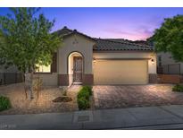 Charming single-Gathering home with a brick driveway, two-car garage, and well-maintained landscaping at 145 Langley Hill Ave, Henderson, NV 89002
