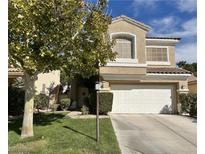 Two-story home featuring a two-car garage, stucco siding, tile roof, and a well-manicured lawn at 1812 Warrenville St, Las Vegas, NV 89117