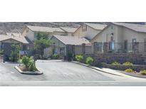 Gated community entrance featuring stone accents and manicured landscaping at 2050 N Los Feliz St # 170, Las Vegas, NV 89156