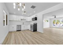Bright kitchen features white cabinets, stainless steel appliances, and ample counter space at 2105 Berkley Ave, Las Vegas, NV 89101