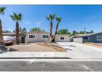 Charming single-story home with desert landscaping and mature palm trees in a sunny locale at 212 View Dr, Las Vegas, NV 89107