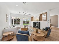 Bright, open living room with modern fireplace, recessed lighting, and sliding doors to the backyard at 2297 Aria Dr, Henderson, NV 89052