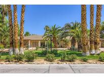 Single story home with palm tree landscaping, mature lawn, and stone accents at 2770 La Casita Ave, Las Vegas, NV 89120