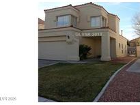 Charming two-story home with a well-maintained front lawn and attached two-car garage, great curb appeal at 309 Clifton Heights Dr, Las Vegas, NV 89145
