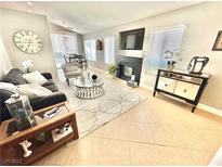Inviting living room features a cozy fireplace, TV, stylish decor, and large windows for natural light at 3329 Hidden Ridge St, Las Vegas, NV 89129