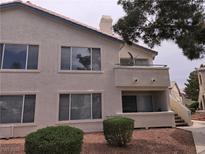 Two story home with a balcony, multiple windows, and low maintenance landscaping at 3425 E Russell Rd # 265, Las Vegas, NV 89120