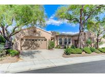 Charming single-story home with mature trees, desert landscaping, and a spacious driveway at 4636 Riva De Romanza St, Las Vegas, NV 89135