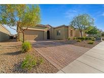 Charming single-story home boasts a brick driveway, desert landscaping, and a two-car garage at 5953 Yellow Ridge Ave, Las Vegas, NV 89131