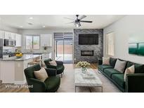 Cozy living room featuring modern fireplace, stylish seating, and an open-concept design to the kitchen at 6525 Raven Hall St, North Las Vegas, NV 89084