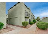 Two-story home featuring quaint balconies, trimmed shrubs, and a well-maintained walkway at 7066 Burcot Ave # 59, Las Vegas, NV 89156