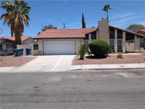 Charming single-story home with a red tile roof and a well-maintained front yard at 7426 Trudy Ln, Las Vegas, NV 89123