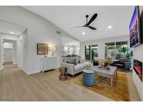 Bright, open living room features modern furnishings, vaulted ceilings and a fireplace at 7701 Sea Cliff Way, Las Vegas, NV 89128