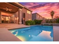 Outdoor pool with stunning backyard patio, landscaped yard and beautiful sunset views at 8620 Copper Mountain Ave, Las Vegas, NV 89129