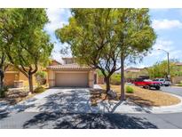 Charming single-story home featuring a well-maintained front yard and a two-car garage at 9373 Wild Lariat Ave, Las Vegas, NV 89178
