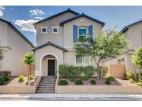Charming two-story home with a landscaped yard, appealing facade, and covered entry at 10556 Sariah Skye Ave, Las Vegas, NV 89166