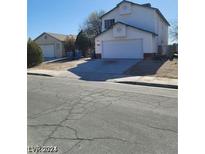Two-story home featuring an attached two-car garage and separate garage on a sunny day at 1745 Starridge Way, Las Vegas, NV 89142