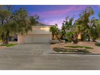Charming home featuring a two-car garage, palm trees, and attractive landscaping, set against a colorful sky at 226 Dalmatian Ln, Las Vegas, NV 89107
