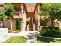 Inviting condo exterior with mature landscaping and a stairway to the upper level entrance at 2925 Wigwam Pkwy # 1124, Henderson, NV 89074