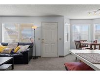 Cozy living room with natural light, featuring a comfortable sofa and dining area in an inviting home at 433 Mesa Blvd # 201, Mesquite, NV 89027