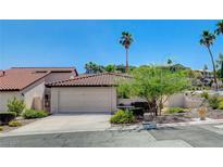 Charming single-story home featuring a red tile roof, well-manicured landscaping, and a two-car garage at 439 Columbia Ct, Boulder City, NV 89005