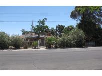 Charming single-story home with a gated front yard and mature trees, enhancing its curb appeal at 4950 Burnham Ave, Las Vegas, NV 89119