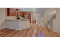 Beautiful kitchen with granite counters, stainless appliances, and an island with bar seating at 7856 Carysford Ave, Las Vegas, NV 89178