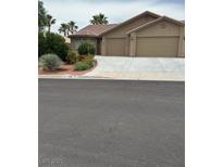 Charming single-story home with a two-car garage, landscaped front yard, and desert-friendly landscaping at 819 Sandsprings St, Henderson, NV 89011