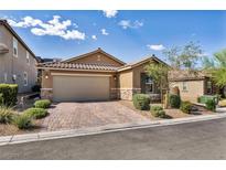Charming single-story home with a two-car garage, paved driveway, and desert landscaping at 8346 Vinamala Ave, Las Vegas, NV 89149