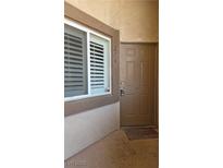 Condo front door with a secure lock, a window with closed blinds, and the unit number above the door at 8725 W Flamingo Rd # 216, Las Vegas, NV 89147