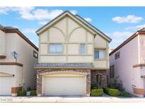Charming two-story home featuring a stone-accented facade, attached two-car garage, and neat front yard landscaping at 9236 Whitekirk Pl, Las Vegas, NV 89145