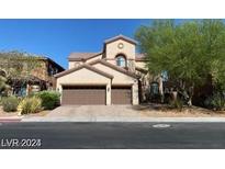 Elegant two-story home featuring a tile roof, stucco facade, and a spacious two-car garage at 9622 Staff Ln, Las Vegas, NV 89178