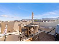 Enjoy the outdoor living space with mountain views on this rooftop patio with dining and lounging furniture at 10733 Red Badge Ave, Las Vegas, NV 89166