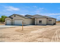 Charming single-story home featuring a three car garage and neutral color palette at 1800 Huckleberry St, Pahrump, NV 89048