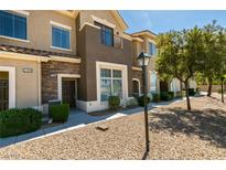 Charming townhouse with stone accents, manicured landscaping, and warm neutral colors at 2786 Fountain Ridge Ln, Henderson, NV 89074