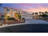 Charming two-story home featuring a well-manicured lawn, three-car garage, and inviting front entrance at 352 Angels Trace Ct, Las Vegas, NV 89148