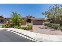Beautiful single-story home featuring a brick driveway, manicured landscaping, and a welcoming entrance at 368 Calabria Beach St, Henderson, NV 89015