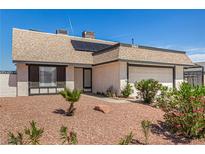 Charming single-story home featuring a gravel front yard, desert landscaping, and an attached two-car garage at 3748 Silent Hill Dr, Las Vegas, NV 89147