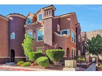 Stylish brown two-story home with well-manicured landscaping and mature trees at 3975 N Hualapai Way # 121, Las Vegas, NV 89129