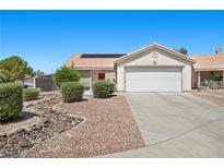 Charming single-story home featuring a well-manicured yard, two car garage, and desert landscaping at 5117 Axbridge Ct, North Las Vegas, NV 89031