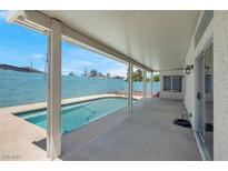 Inviting covered patio with a pool and spa, ideal for outdoor relaxation and entertainment at 519 Landra Ln, Henderson, NV 89015