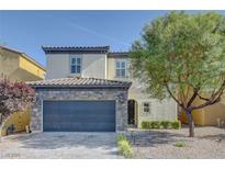 Charming two-story home featuring a stone accented facade and a well-maintained front yard at 599 Wounded Star Ave, Las Vegas, NV 89178