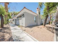 Inviting condo exterior featuring well-maintained landscaping and desert accents at 6006 Vegas Dr, Las Vegas, NV 89108